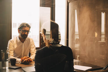 Mature client listening to female lawyer in office meeting - MASF14521