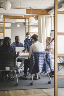 Male and female coworkers brainstorming in meeting at creative office - MASF14567