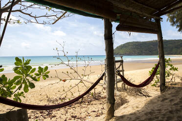 Hammocks in the foreground and beach in background with sunny weather - CAVF69100