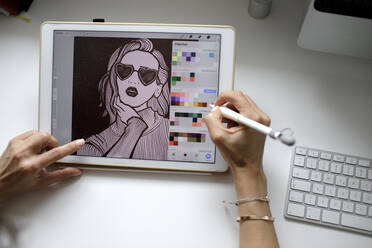 Female web designer using tablet at home - KMKF01142