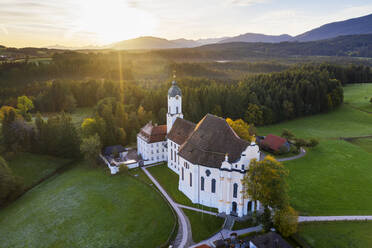 Deutschland, Bayern, Oberbayern, Pfaffenwinkel, Wies, Luftaufnahme der Wallfahrtskirche Wies zum Gegeißelten Heiland bei Sonnenaufgang - SIEF09313