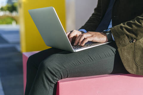 Close-up of businessman's hands using laptop outside stock photo
