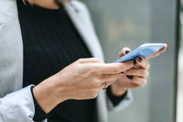 Close-up of woman using cell phone outdoors - KIJF02820