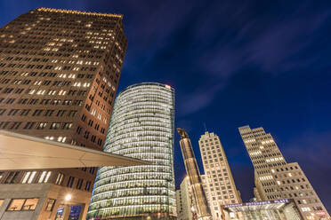 Germany, Berlin, Mitte, Potsdamer Platz, Kollhoff-Tower, Bahntower, Beisheim-Center, Low angle view of skyscrapers at dusk - WDF05590