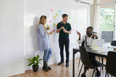 Young business people talking in a modern office - IGGF01455