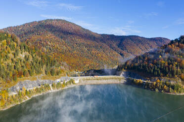 Germany, Bavaria, Lenggries, Aerial view of Sylvenstein Dam in autumn - SIEF09324