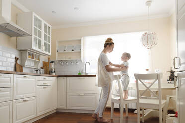 Mother with her little boy in the kitchen - EYAF00684