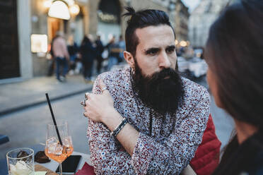 Man gazing intensely into woman's eyes in cafe - CUF53506