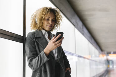 Woman with headphones and smartphone - AHSF01273