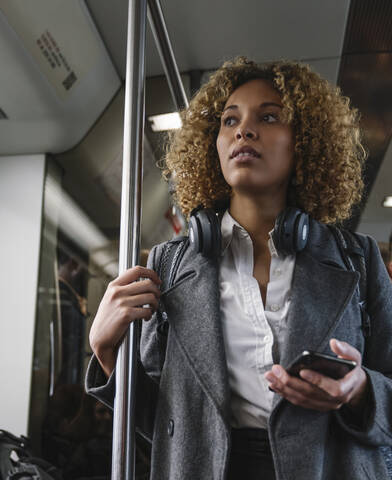 Woman with smartphone on a subway stock photo