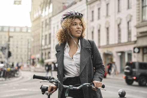 Woman with bicycle in the city, Berlin, Germany - AHSF01312