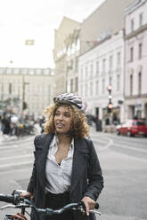 Frau mit Fahrrad in der Stadt, Berlin, Deutschland - AHSF01314