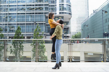 Cheerful lesbian couple in the city, London, UK - FBAF00979