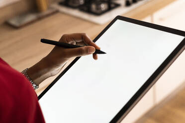 Close-up of woman using graphics tablet and stylus - GIOF07850