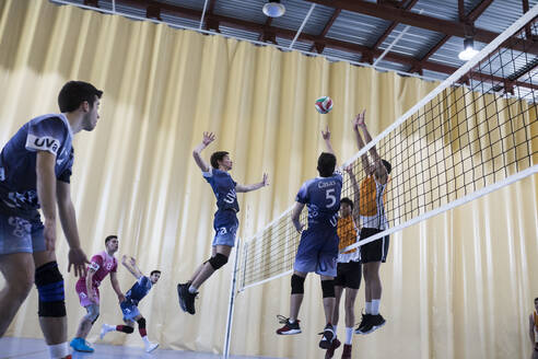 Man jumping during a volleyball match - ABZF02847