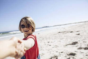 Porträt eines lächelnden Mädchens, das sich am Strand die Hände hält, Kapstadt, Westkap, Südafrika - MCF00372