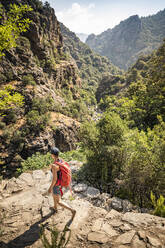 Female hiker during hike, Gorges de Spelunca, Ota, Corse-du-Sud, Corsica, France - MSUF00030