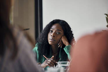 Portrait of businesswoman during a meeting in office - ZEDF02742