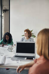 Businesswomen having a meeting in office - ZEDF02753