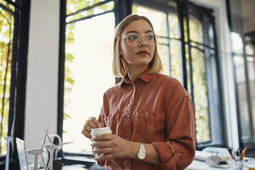 Businesswoman having a coffee break in office - ZEDF02782