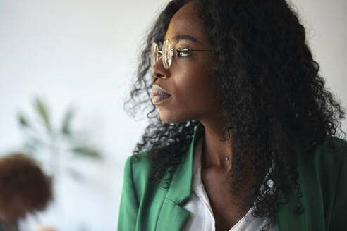 Portrait of a businesswoman in office looking sideways - ZEDF02815