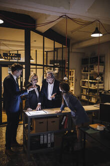 Business people discussing with girl and shining tablet in office - GUSF02735