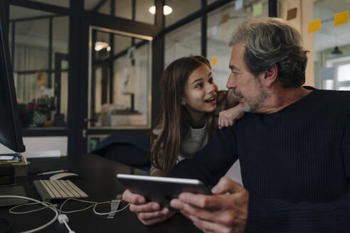 Casual senior buisinessman and girl with tablet in office - GUSF02869