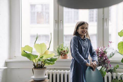 Happy girl with standing at the window in office stock photo