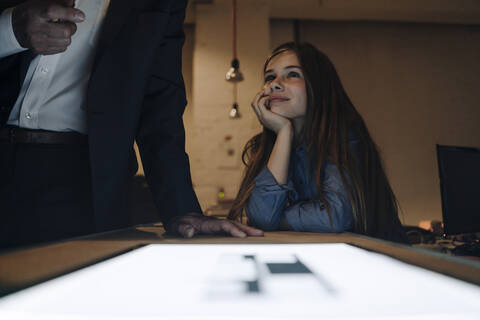 Businessman and girl with shining tablet in office stock photo