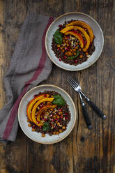 Bowls of quinoa with baked pumpkin, chick-peas, pomegranate, basil, walnuts and pumpkin seeds - LVF08441