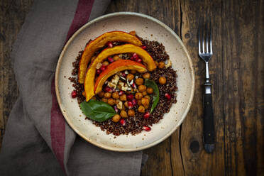Bowl of quinoa with baked pumpkin, chick-peas, pomegranate, basil, walnuts and pumpkin seeds - LVF08442