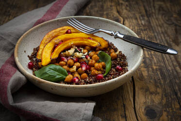Bowl of quinoa with baked pumpkin, chick-peas, pomegranate, basil, walnuts and pumpkin seeds - LVF08443