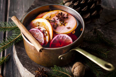 Mulled wine with oranges and cinnamon in a saucepan - SBDF04136