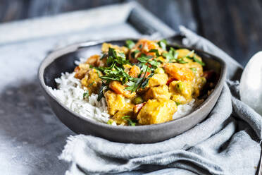 Bowl of vegan curry with potatoes, carrots, peas, parsley and pumpkin - SBDF04156