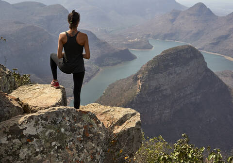 Frau auf dem Gipfel eines Felsens im Blyde River Canyon, Südafrika, lizenzfreies Stockfoto