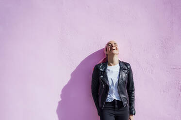 Portrait of laughing woman with pink headscarf, has cancer - JCMF00320