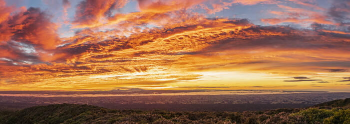 New Zealand, Dramatic sunrise over Tongariro National Park with silhouettes of volcanoes in distance - FOF11217