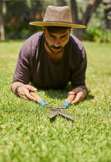 Man pruning the lawn in garden - VEGF00887