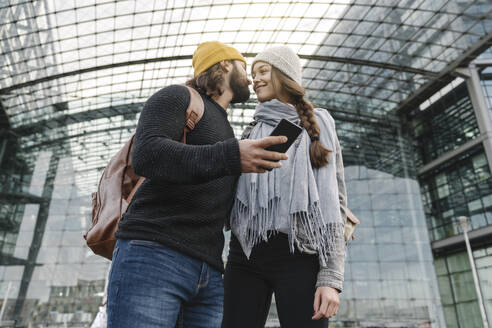 Verliebtes junges Paar mit Smartphone am Hauptbahnhof, Berlin, Deutschland - AHSF01418