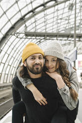 Portrait of smiling young couple at the station platform, Berlin, Germany - AHSF01434