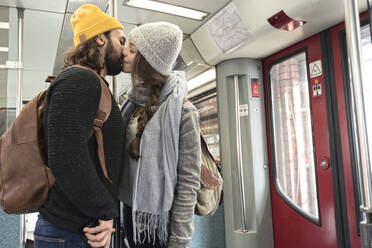 Junges Paar küsst sich in einer U-Bahn - AHSF01458