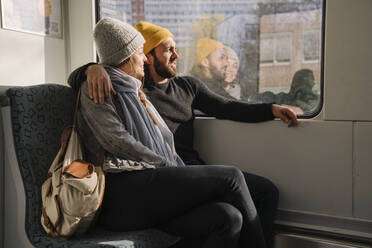 Junges Paar in einer U-Bahn schaut aus dem Fenster - AHSF01459