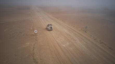 Drone view of a 4x4 in the foggy desert, Namibia - VEGF00911