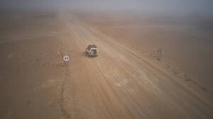 Drohnenansicht eines Geländewagens in der nebligen Wüste, Namibia - VEGF00911