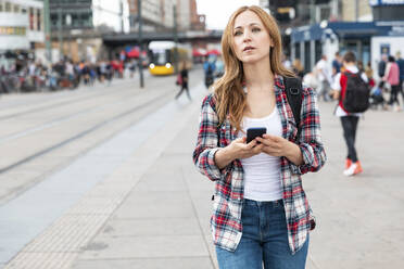 Woman with smartphone in the city, Berlin, Germany - WPEF02299