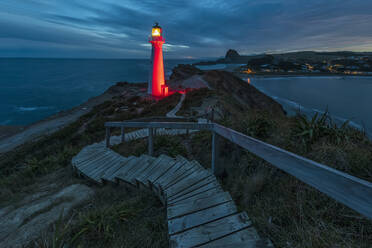 Beleuchteter Leuchtturm in der Abenddämmerung, Castlepoint, Neuseeland - FOF11251