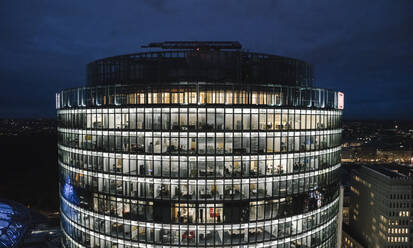 View to lighted modern office building at night, Potsdamer Platz, Berlin, Germany - AHSF01574