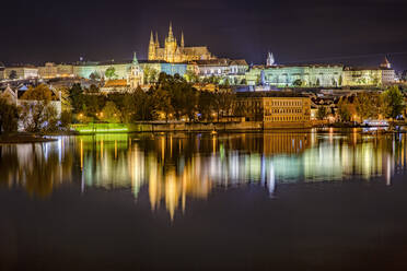 Czech Republic, Prague, Vltava river, Prague Castle and surrounding buildings at night - YRF00225