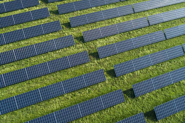 Bavaria, Germany, Rows of solar panels arranged on grass - RUEF02383