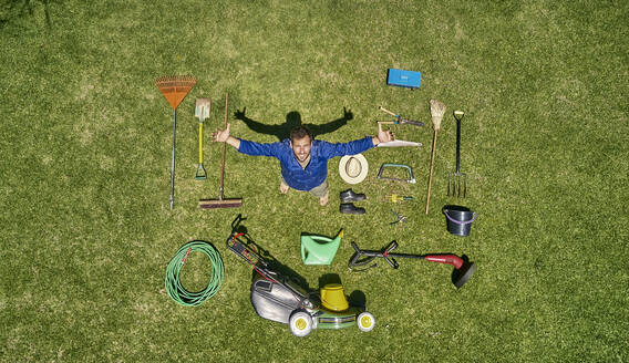 View from above of a gardener in standing on meadow with all the tools he need for take care of garden - VEGF00989